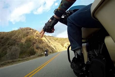 Why Do Motorcycle Riders Point to the Ground: A Signal or a Secret Handshake?